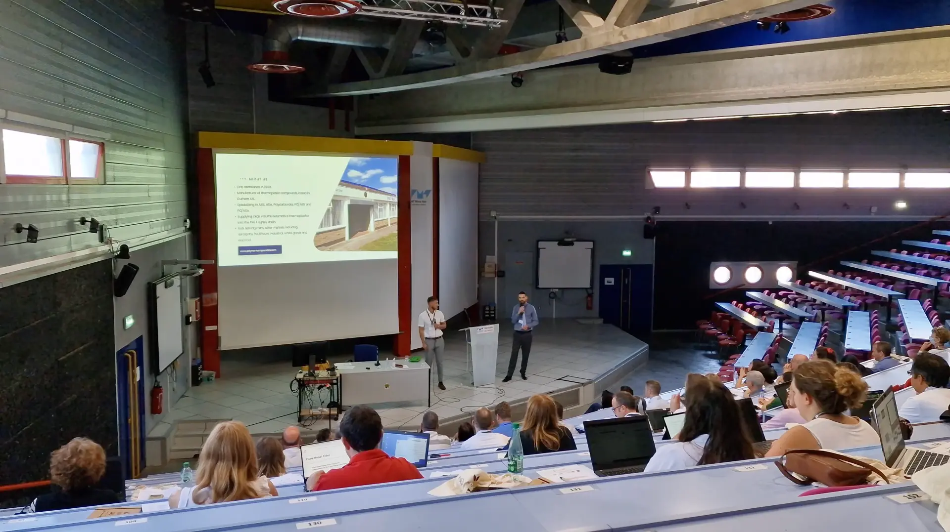 James Houlder presenting alongside a colleague to an audience at a university in Alès, France.